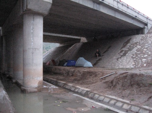 hobo living under a bridge