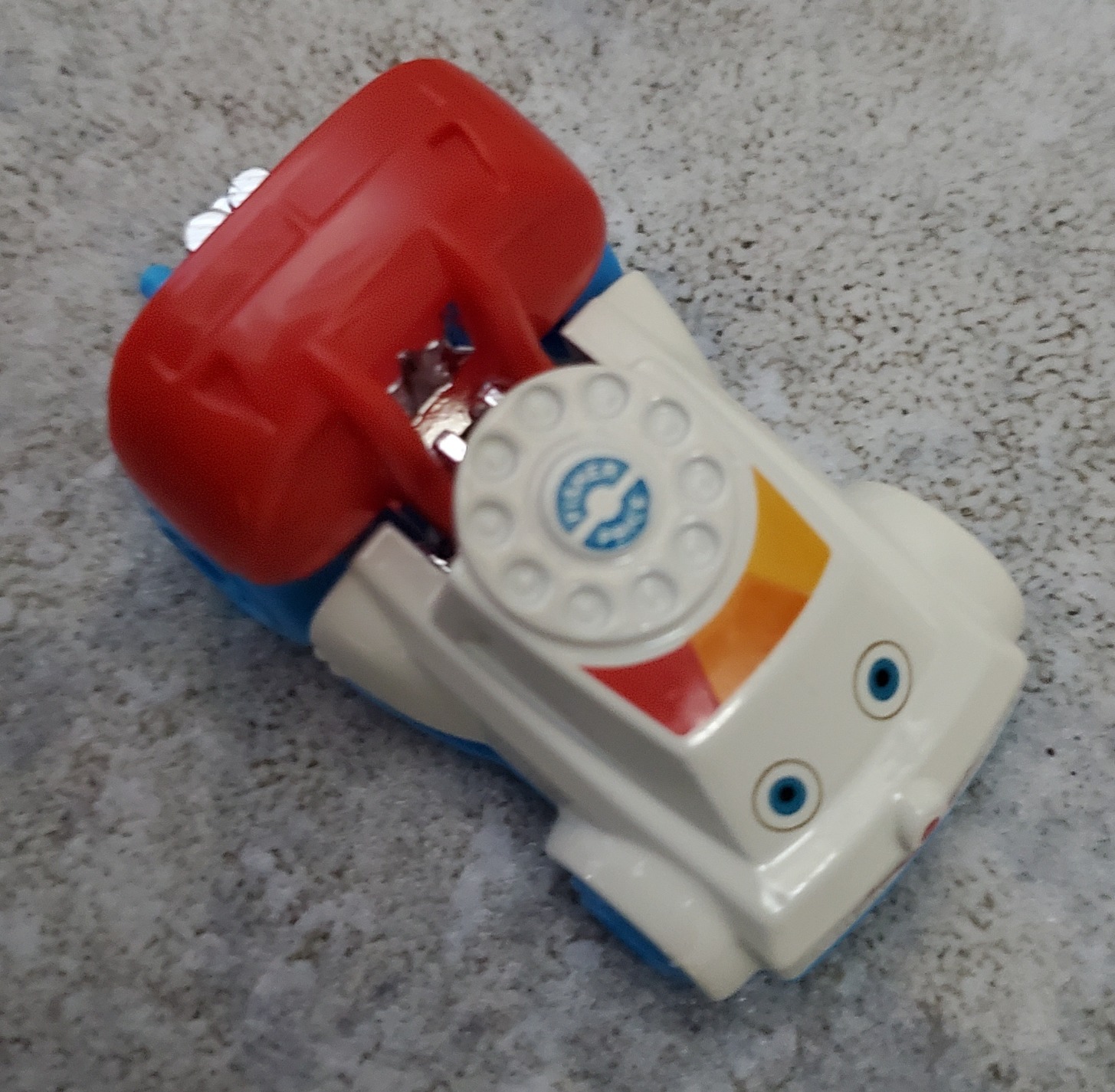 A hot wheels car shaped like a Fisher price toy shaped like a rotary telephone